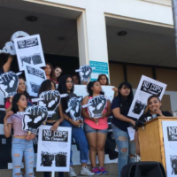 Students hold an events protesting police officers on their campus.
